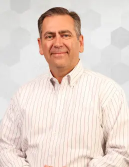 Photo of Motion President, Randy Breaux, with a grey abstract background